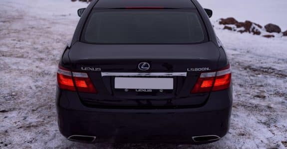 rear-view-of-a-black-lexus-ls-600h-parked-on-snow-showcasing-luxury-in-a-winter-setting